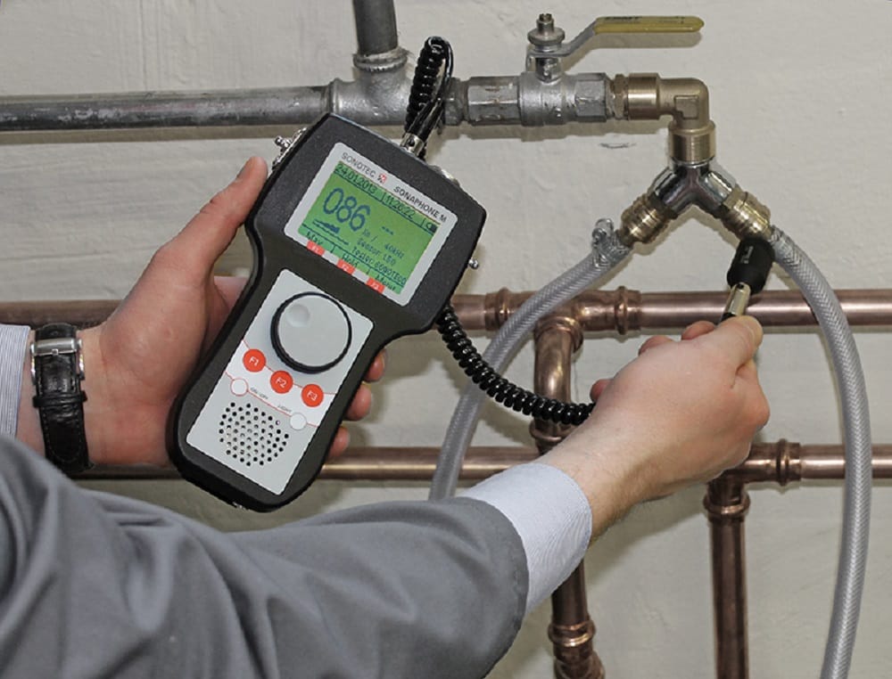 Plumber testing pipes with electronic leak detection equipment in Tarpon Springs