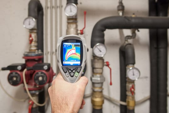 Plumber using a thermal imaging camera to inspect pipes in Tarpon Springs