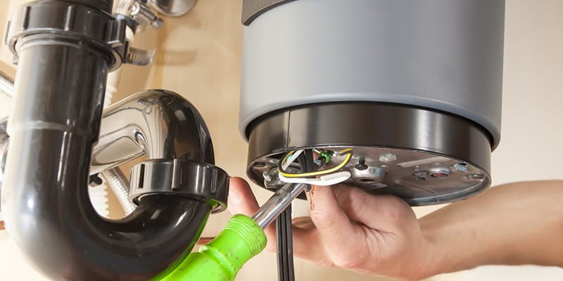 Technician repairing the heating element of a water heater in Tarpon Springs