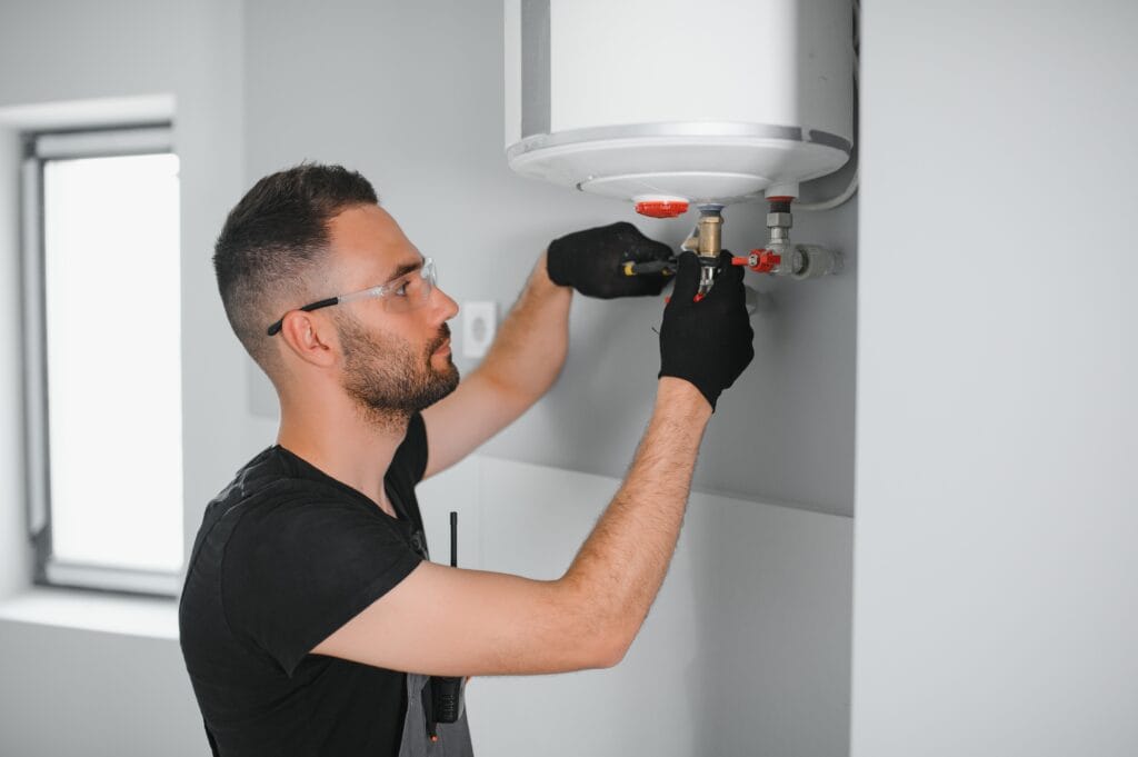 Technician performing water heater maintenance in Tarpon Springs