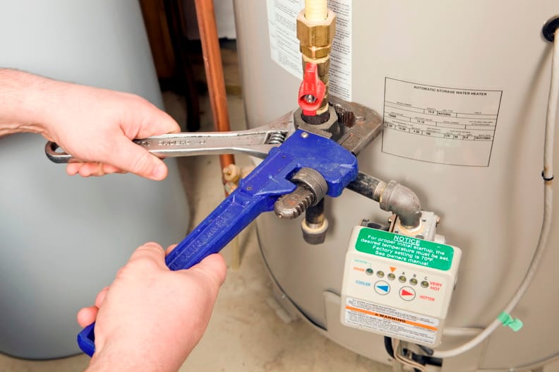 Plumber repairing a water heater valve in Tarpon Springs